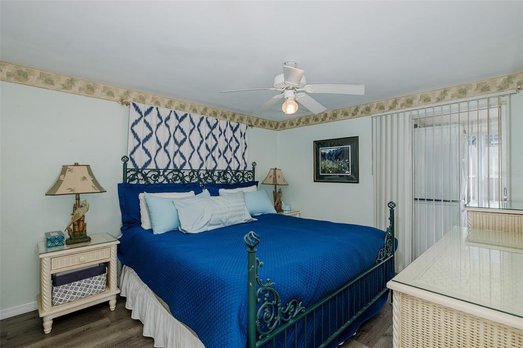 4206 Richmere Drive, Unit 3 New Port Richey, FL 34652 - Photo 20 of 41 a bedroom with a bed and a chandelier