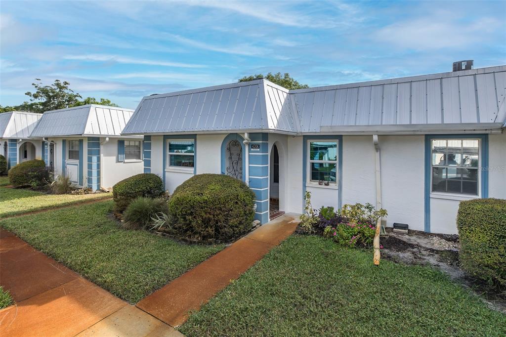 4206 Richmere Drive, Unit 3 New Port Richey, FL 34652 - Photo 2 of 41 a view of a house with a yard and plants