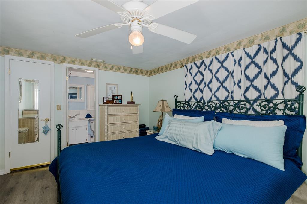 4206 Richmere Drive, Unit 3 New Port Richey, FL 34652 - Photo 22 of 41 a living room with a bed furniture and a chandelier