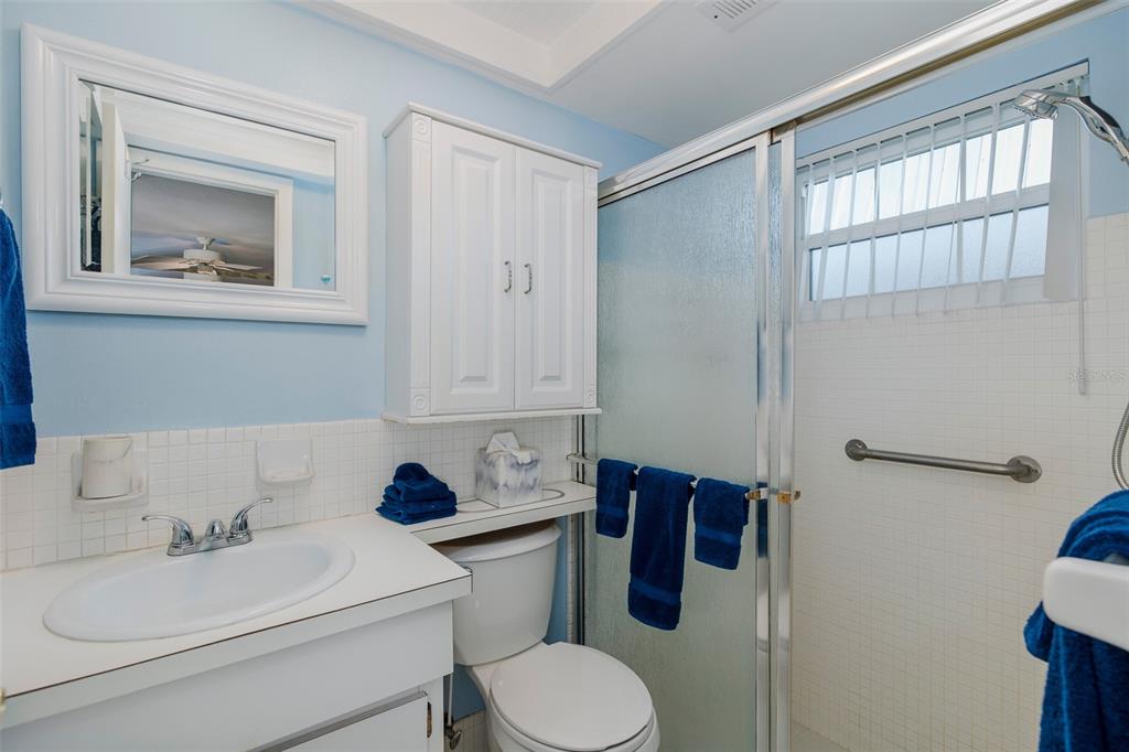 4206 Richmere Drive, Unit 3 New Port Richey, FL 34652 - Photo 24 of 41 a bathroom with a toilet sink a mirror and vanity