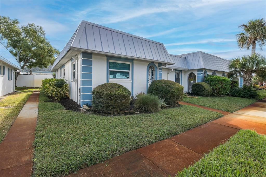4206 Richmere Drive, Unit 3 New Port Richey, FL 34652 - Photo 3 of 41 a view of a house with a yard and plants