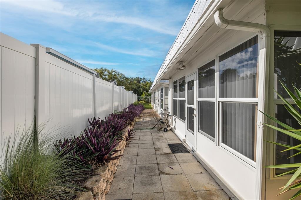 4206 Richmere Drive, Unit 3 New Port Richey, FL 34652 - Photo 35 of 41 a view of a house with a potted plant and floor to ceiling window