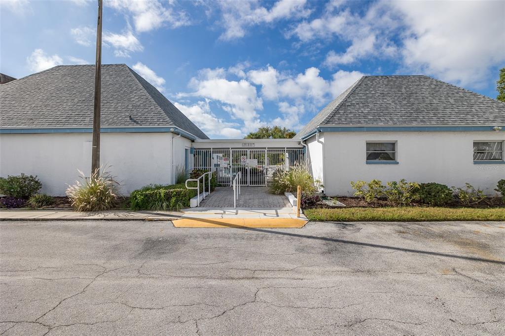 4206 Richmere Drive, Unit 3 New Port Richey, FL 34652 - Photo 36 of 41 a front view of a house with a yard and potted plants