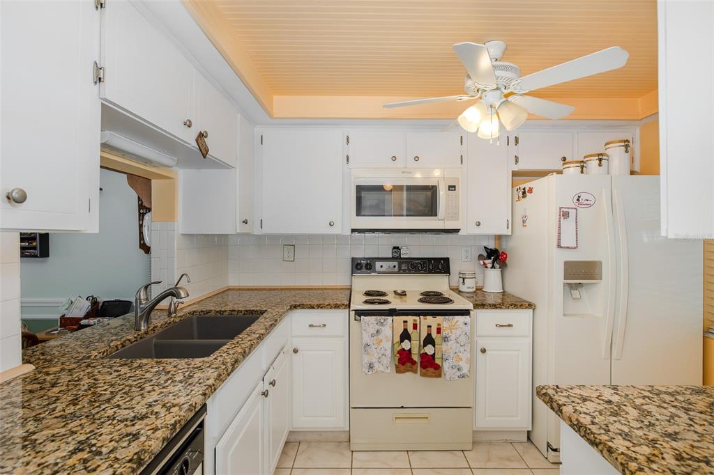 4206 Richmere Drive, Unit 3 New Port Richey, FL 34652 - Photo 9 of 41 a kitchen with stainless steel appliances granite countertop a sink stove and refrigerator