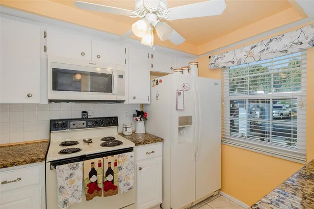 a kitchen with stainless steel appliances a stove a refrigerator and a cabinets