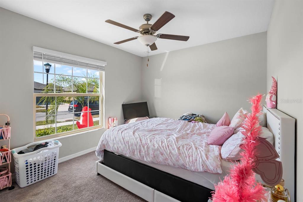 889 Calico Scallop Street Ruskin, FL 33570 - Photo 15 of 32 a bedroom with a bed and a window