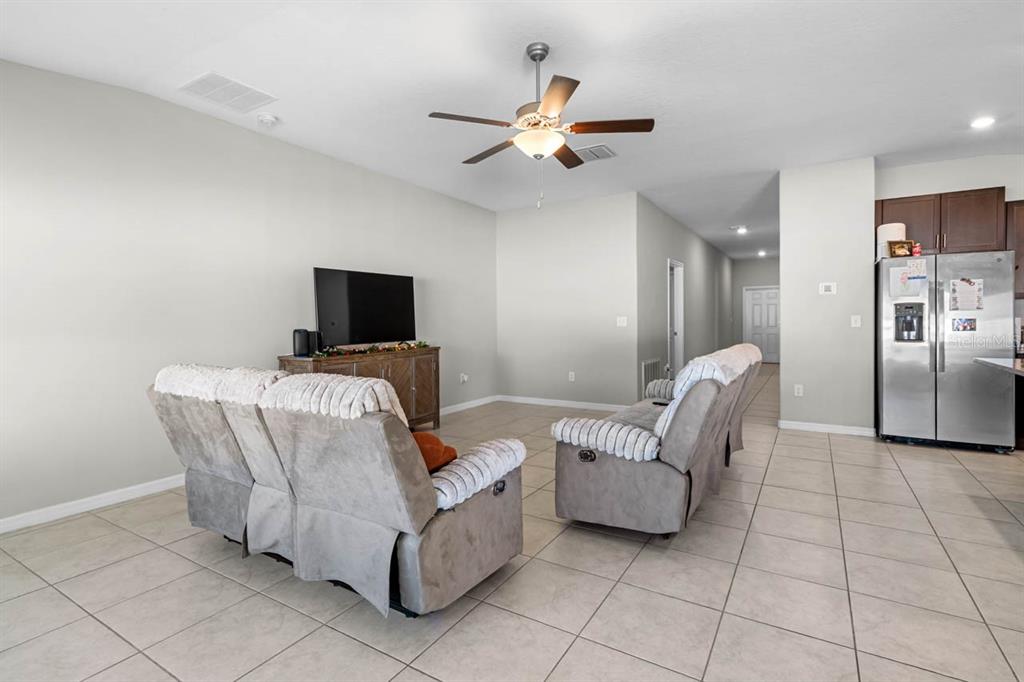 889 Calico Scallop Street Ruskin, FL 33570 - Photo 18 of 32 a living room with furniture and a flat screen tv