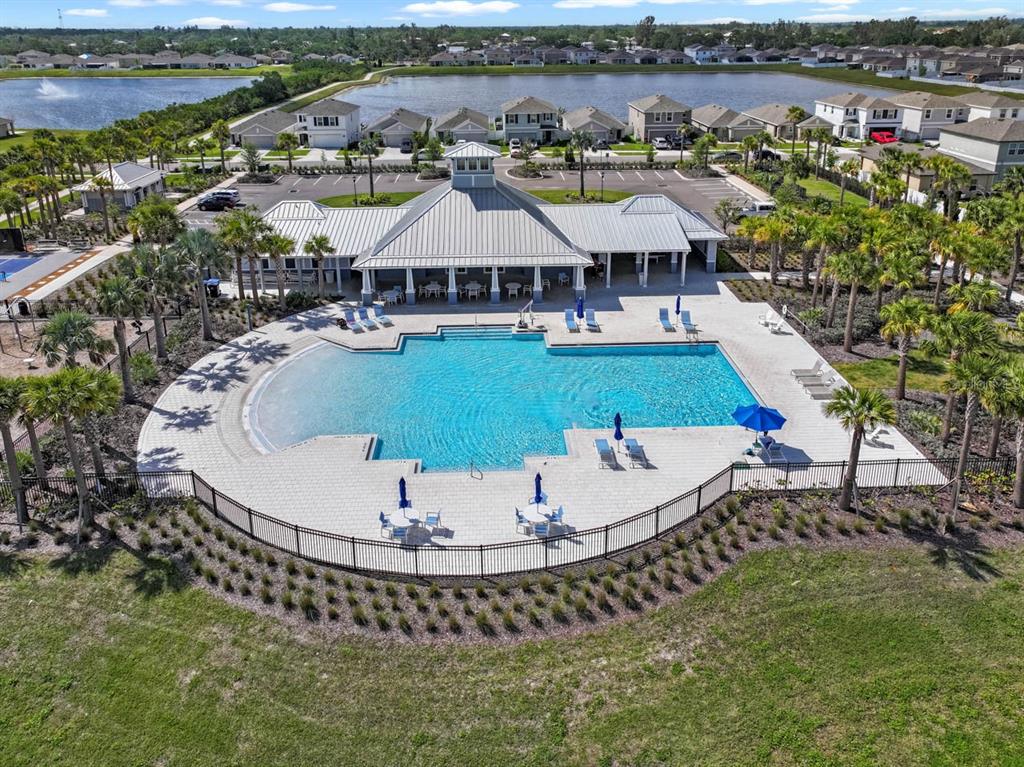 889 Calico Scallop Street Ruskin, FL 33570 - Photo 21 of 32 an aerial view of a house with a swimming pool outdoor seating and yard