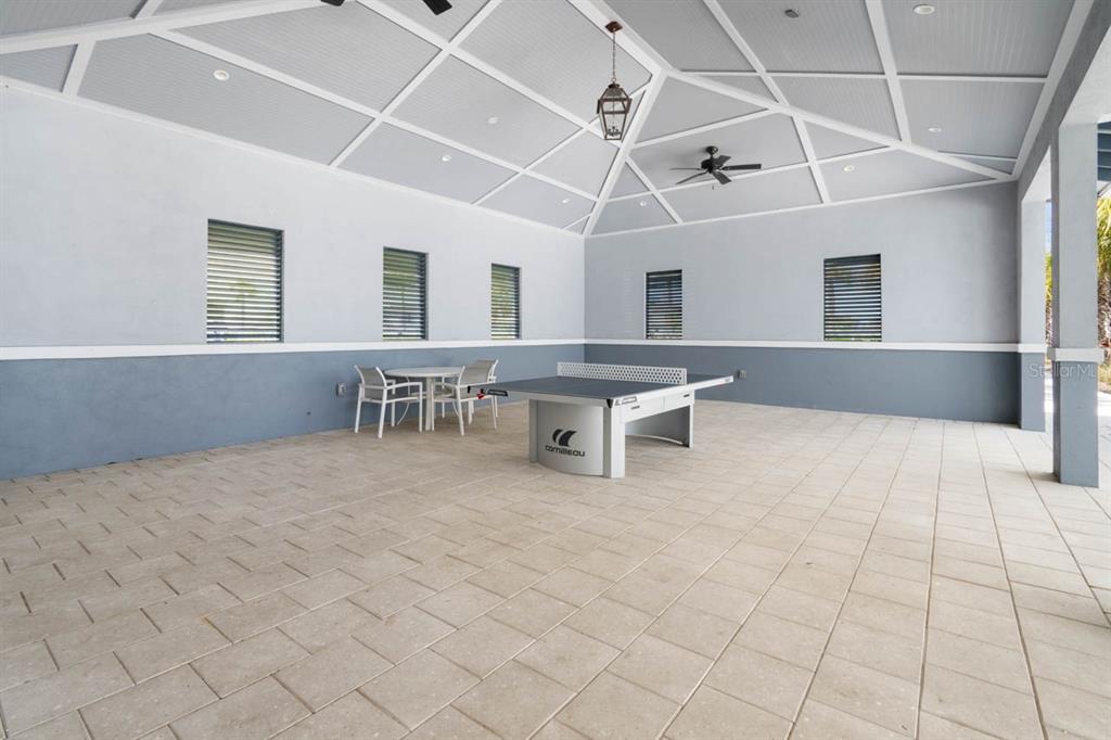 889 Calico Scallop Street Ruskin, FL 33570 - Photo 28 of 32 a view of a kitchen with furniture and a chandelier