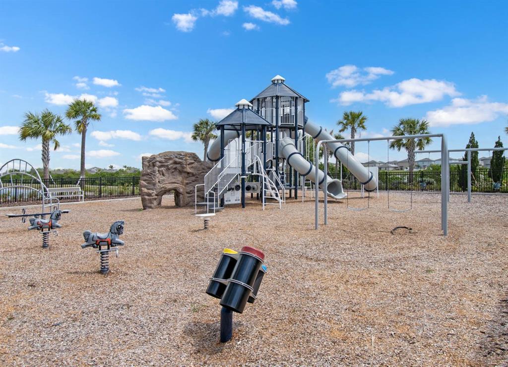 889 Calico Scallop Street Ruskin, FL 33570 - Photo 30 of 32 a view of a park with swings and slides