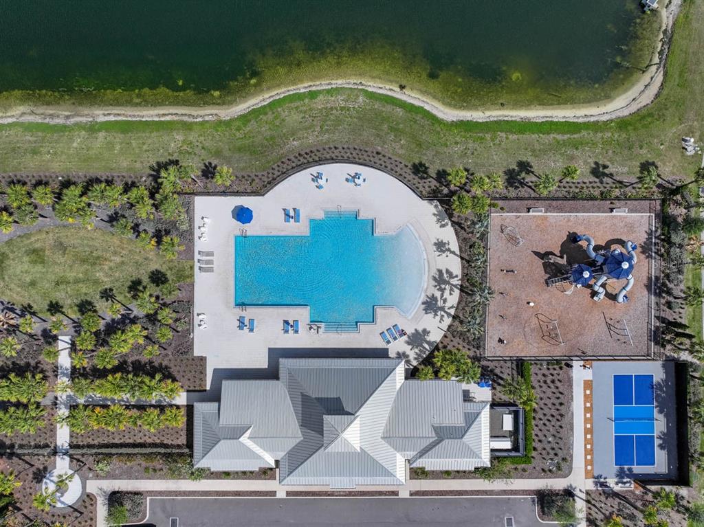 889 Calico Scallop Street Ruskin, FL 33570 - Photo 32 of 32 an aerial view of a house with a garden and entryway
