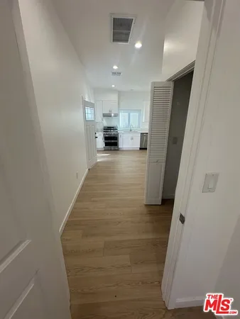 a view of a kitchen from a hallway