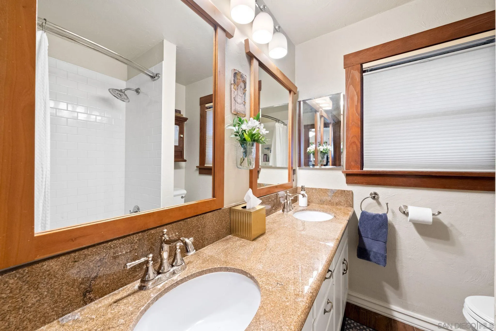 4536 Nebo Drive La Mesa, CA 91941 - Photo 31 of 58 a bathroom with a granite countertop sink and a mirror
