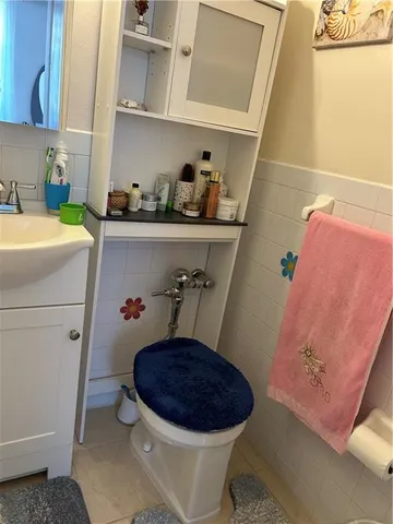 a bathroom with a sink a toilet and shower curtain