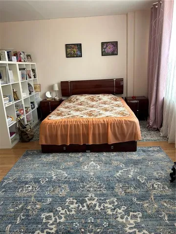 a spacious bedroom with a bed and a window