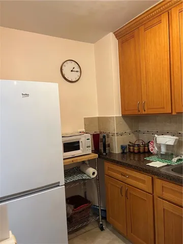 a kitchen with a sink cabinets and appliances