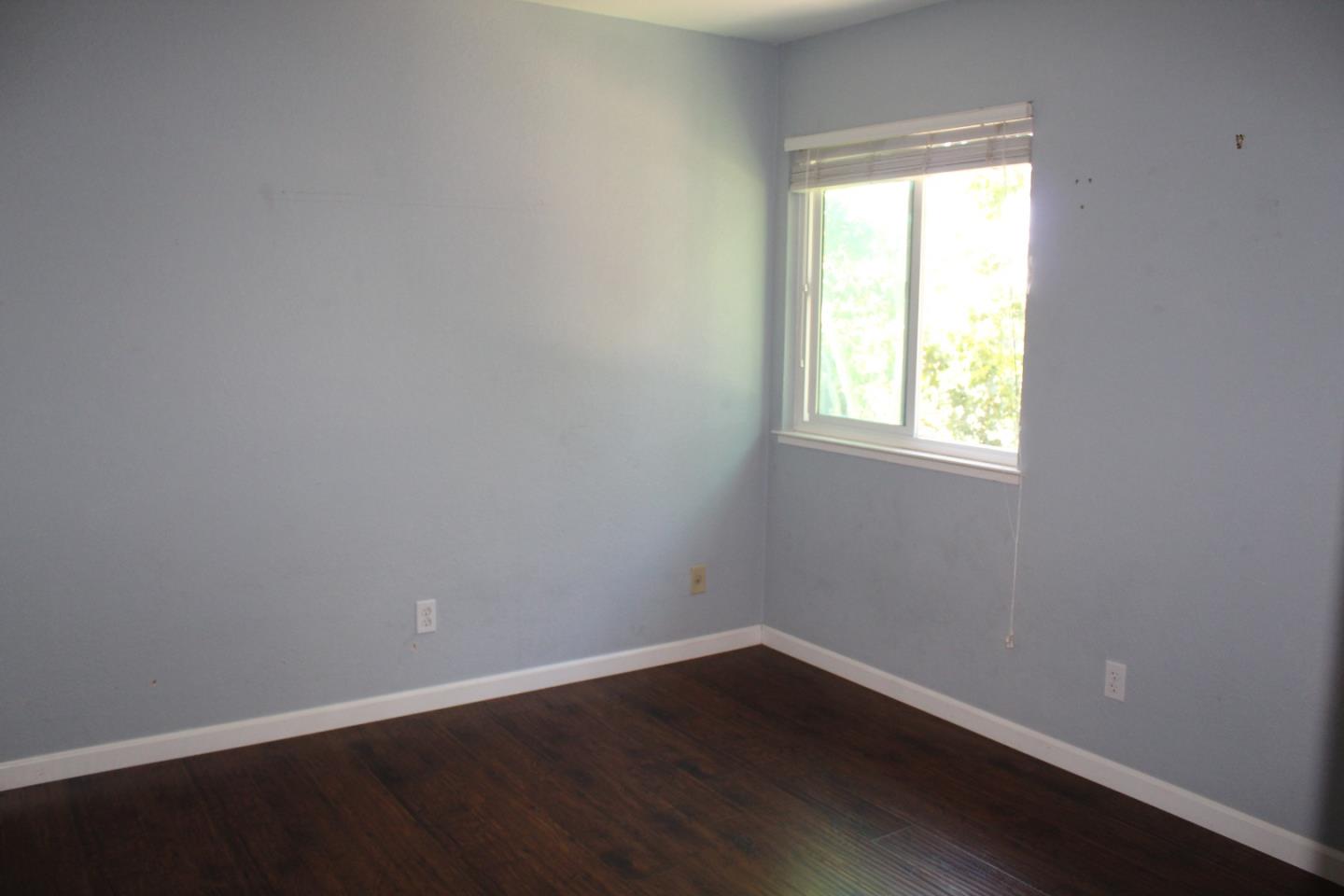 1025 Fillippelli Drive Gilroy, CA 95020 - Photo 19 of 47 an empty room with wooden floor and windows