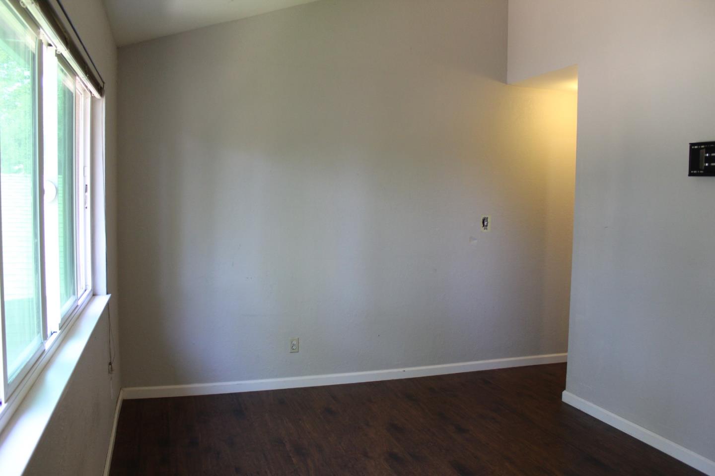 1025 Fillippelli Drive Gilroy, CA 95020 - Photo 24 of 47 an empty room with wooden floor and windows