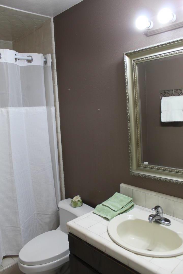 1025 Fillippelli Drive Gilroy, CA 95020 - Photo 28 of 47 a bathroom with a sink toilet and mirror