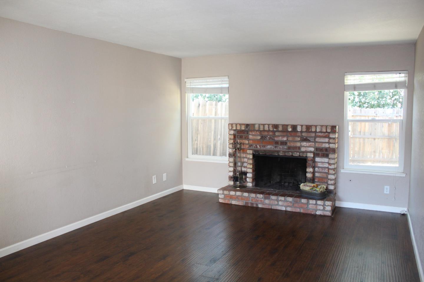 1025 Fillippelli Drive Gilroy, CA 95020 - Photo 4 of 47 a living room with a fireplace and wooden floor