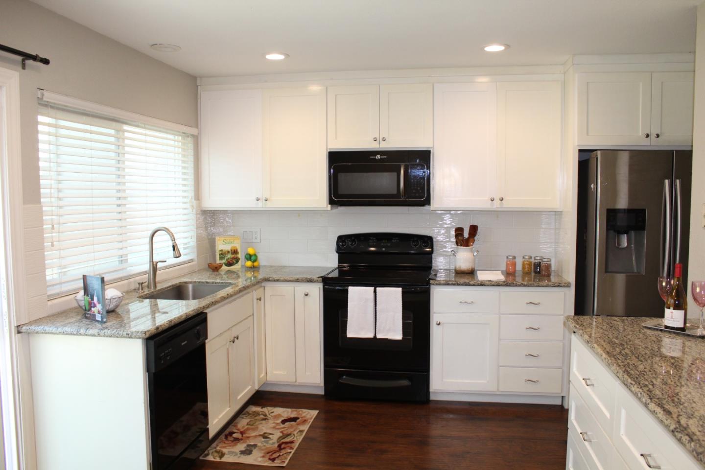 1025 Fillippelli Drive Gilroy, CA 95020 - Photo 8 of 47 a kitchen with granite countertop a sink stainless steel appliances and cabinets