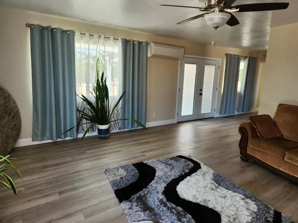 a living room with furniture and a potted plant