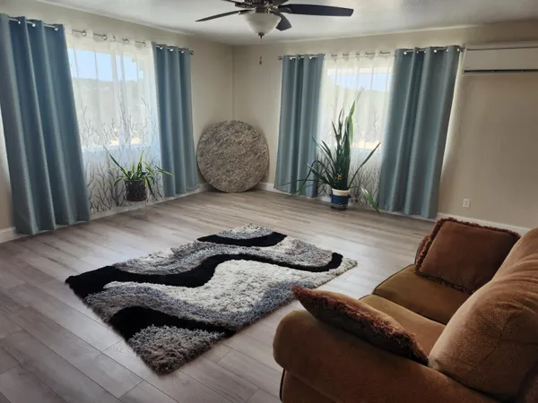 a living room with furniture and a large window