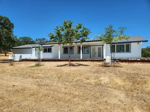 a house with trees in the background