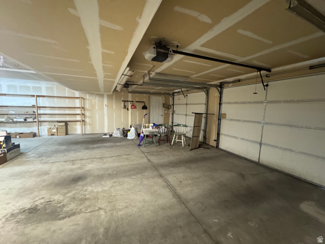 88 Canterbury Lane Logan, UT 84321 - Photo 32 of 37 Spacious garage featuring concrete flooring and exposed ceiling joists
