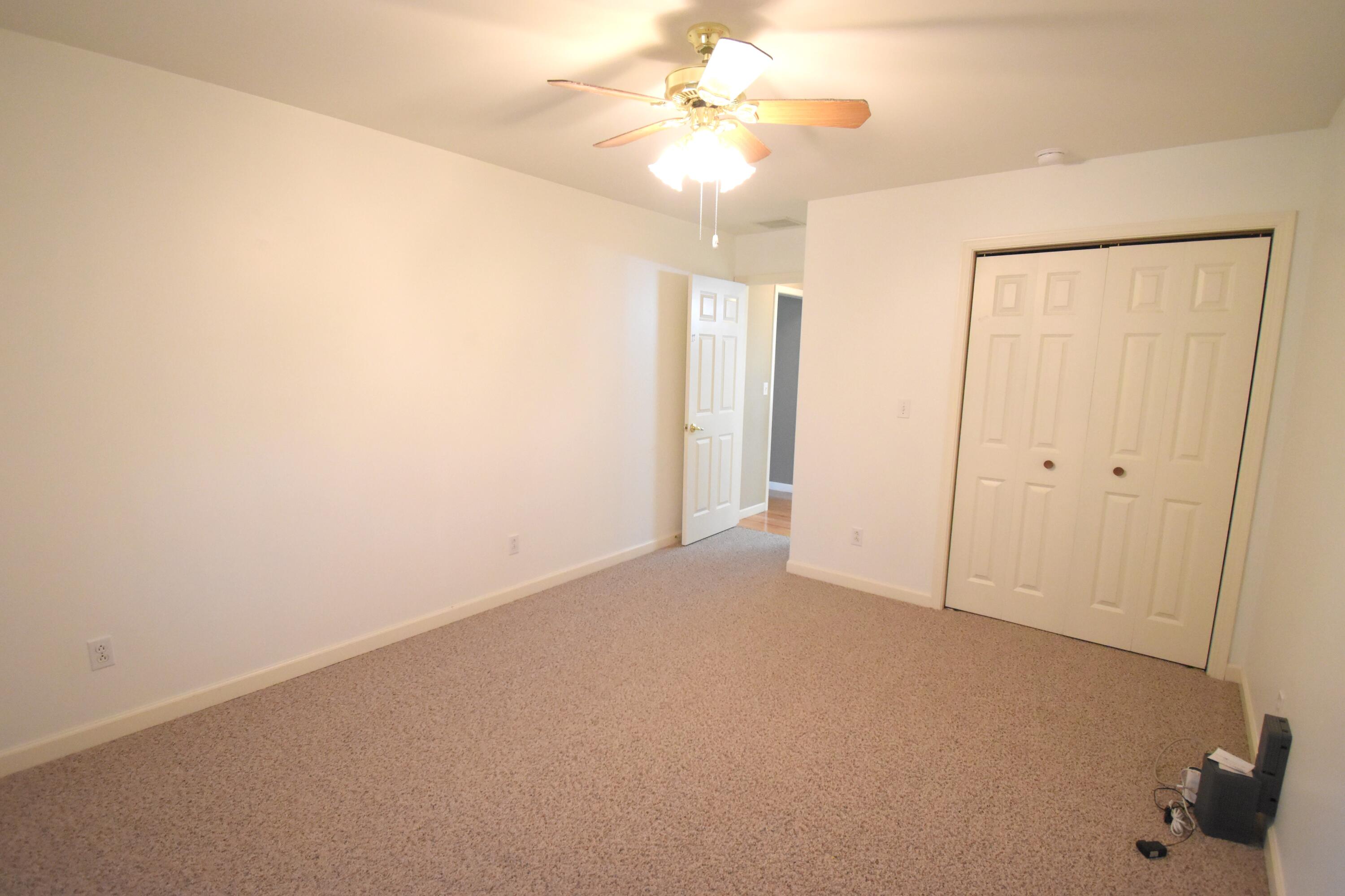 522 Pheasant Run Rensselaer, IN 47978 - Photo 46 of 55 an empty room with a chandelier fan and closet area