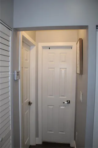 a bathroom with a shower curtain and a potted plant