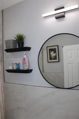 a bed sitting in a bedroom next to a bathroom