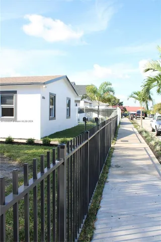 a view of a house with wooden fence