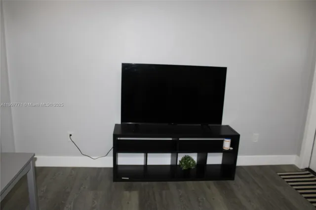 a kitchen with stainless steel appliances a sink a stove a microwave and refrigerator