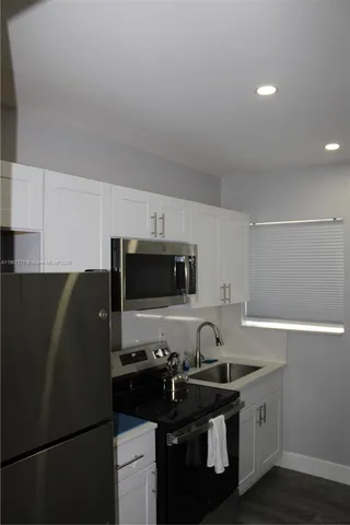 a bed sitting in a bedroom next to a bathroom