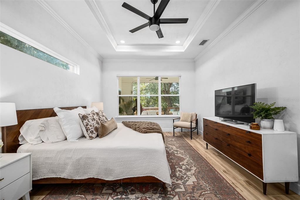 1068 Southwest 120th Drive Gainesville, FL 32607 - Photo 21 of 43 a bedroom with a bed and a flat screen tv