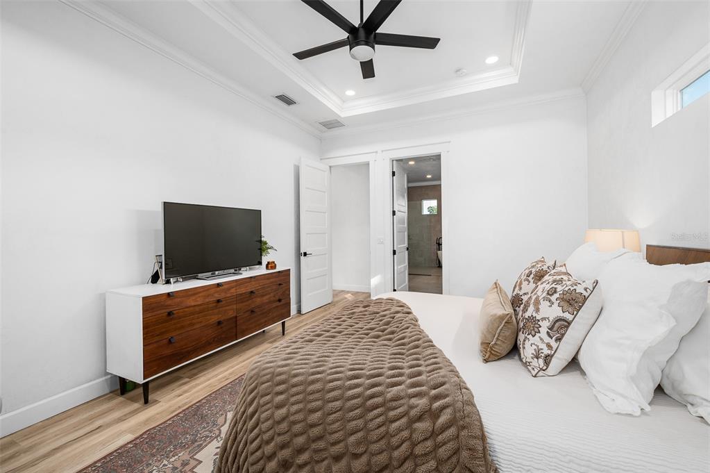 1068 Southwest 120th Drive Gainesville, FL 32607 - Photo 22 of 43 a bedroom with a bed and a flat screen tv