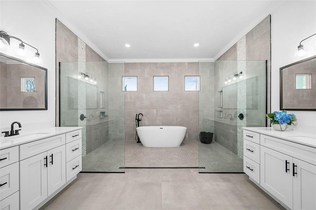 1068 Southwest 120th Drive Gainesville, FL 32607 - Photo 24 of 43 a spacious bathroom with a double vanity sink mirror and bathtub