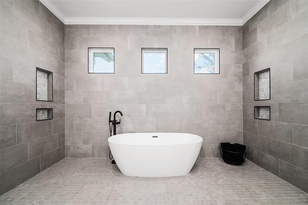 1068 Southwest 120th Drive Gainesville, FL 32607 - Photo 27 of 43 a bathroom with a bathtub and a shower