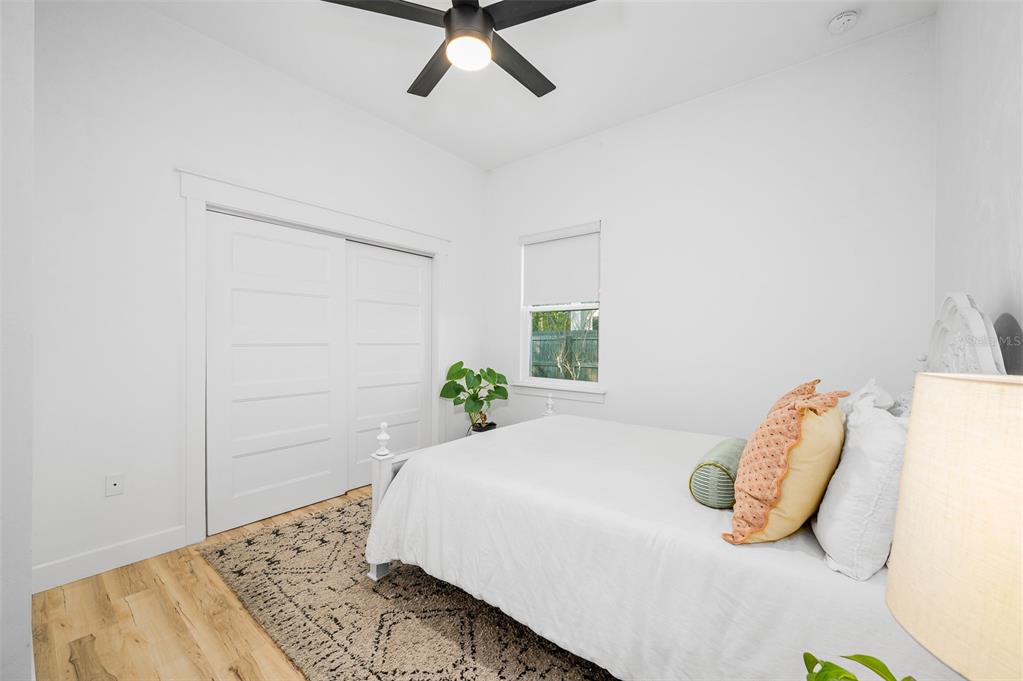 1068 Southwest 120th Drive Gainesville, FL 32607 - Photo 29 of 43 a bedroom with a bed and a potted plant