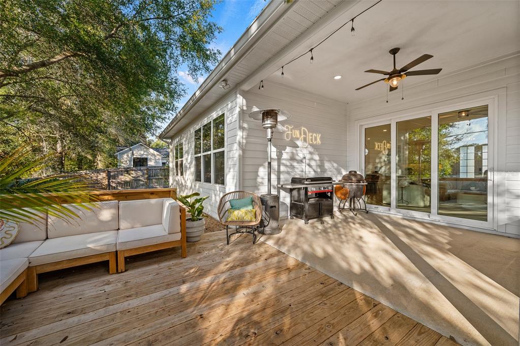 1068 Southwest 120th Drive Gainesville, FL 32607 - Photo 40 of 43 a living room with patio furniture and a large window
