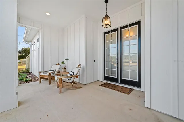 a view of a livingroom with furniture and floor to ceiling window