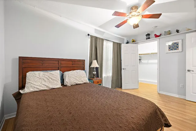 a bedroom with a large bed and a chandelier