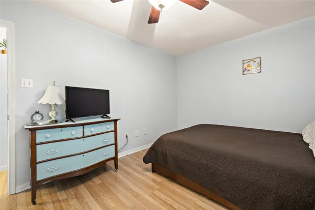 a bedroom with a bed and flat screen tv