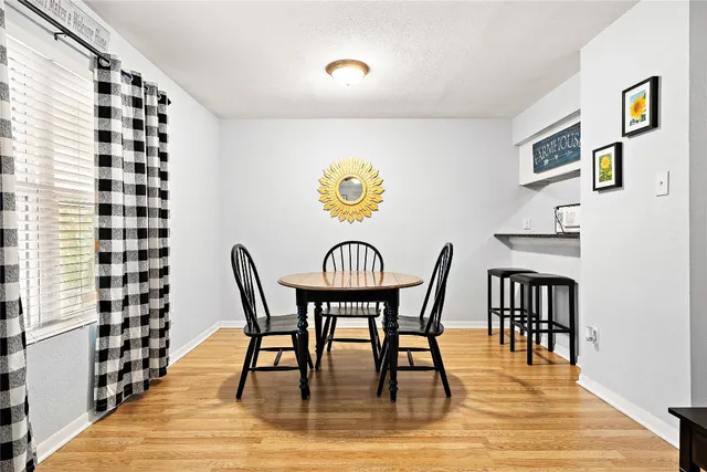 a view of a dining room with furniture and wooden floor