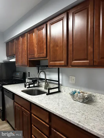 a kitchen with sink and cabinets