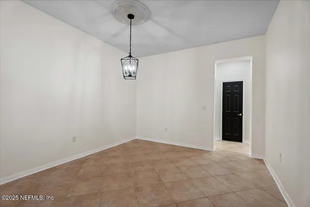 a view of a kitchen with a sink and refrigerator