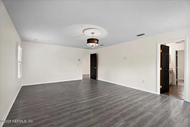 a view of a room with wooden floor and fan
