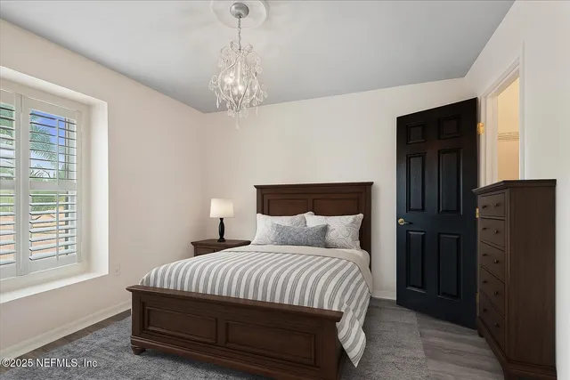 a bedroom with a bed and a chandelier