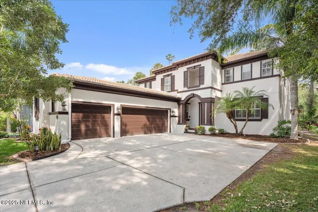 a view of a house with a backyard